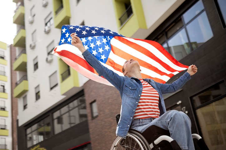 Woman in a Wheelchair Raising a Flag | Perfect Power Wheelchair