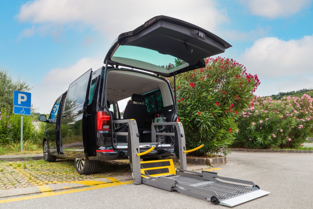 A mobility van with an open door and a ramp extended for wheelchair access.