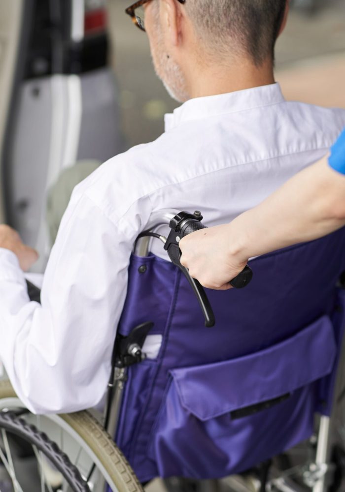 A Person Pushing a Man in Wheelchair | Quality Medical Equipment